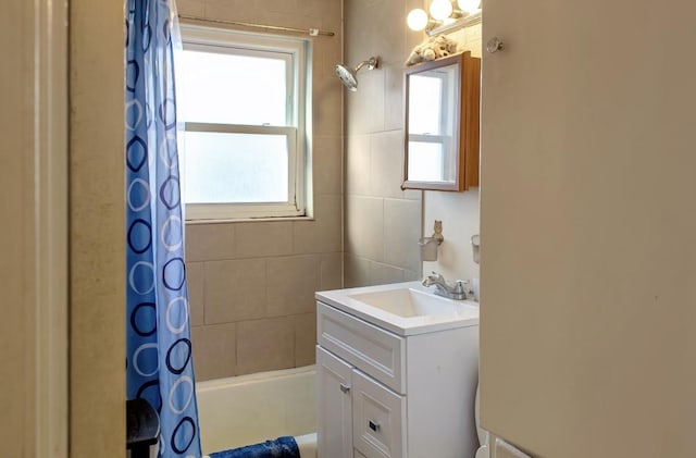 bathroom featuring vanity and shower / bath combo with shower curtain