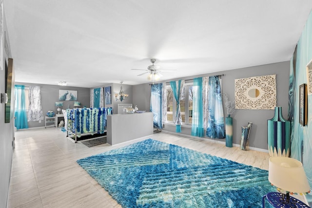 living room featuring ceiling fan with notable chandelier