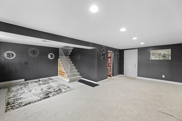 basement featuring light colored carpet