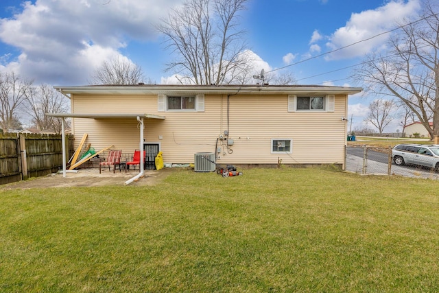 rear view of house with a yard, a patio, and cooling unit