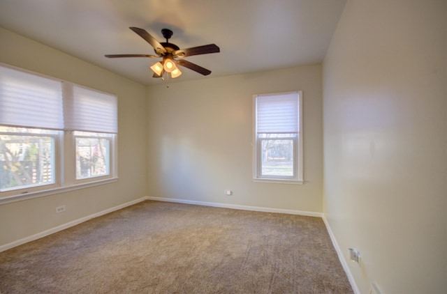 carpeted empty room featuring ceiling fan