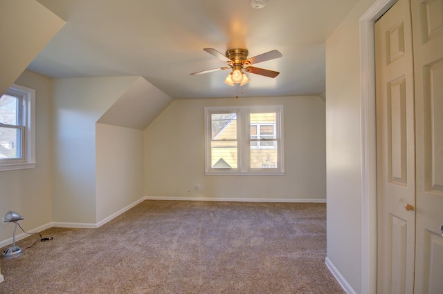 bonus room with ceiling fan, light carpet, and a wealth of natural light