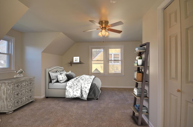 carpeted bedroom with multiple windows, ceiling fan, and lofted ceiling