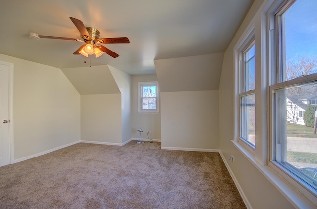 bonus room featuring light carpet, ceiling fan, and vaulted ceiling