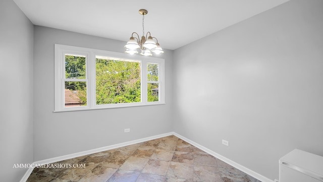 empty room featuring an inviting chandelier