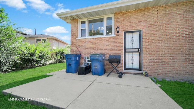 doorway to property with a lawn and a patio area