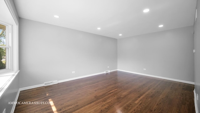 empty room with dark hardwood / wood-style flooring