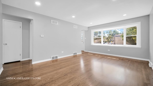 empty room with hardwood / wood-style flooring