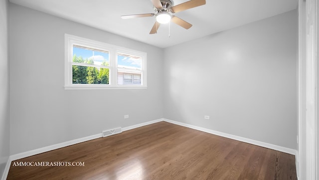 empty room with hardwood / wood-style flooring and ceiling fan