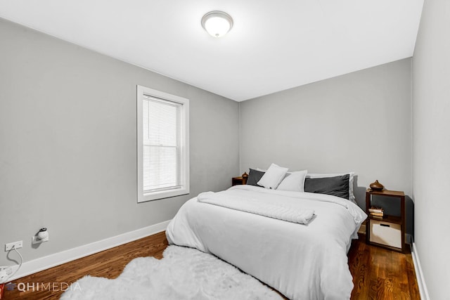 bedroom featuring dark hardwood / wood-style flooring