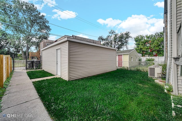 view of yard featuring cooling unit and a storage shed