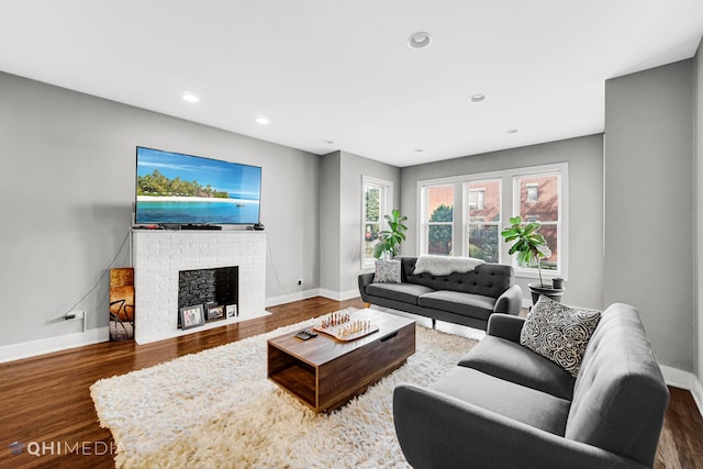 living room with a fireplace and dark hardwood / wood-style floors