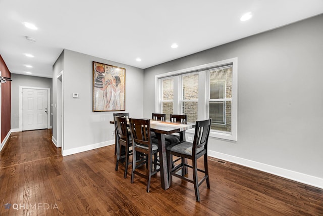 dining area with dark hardwood / wood-style flooring