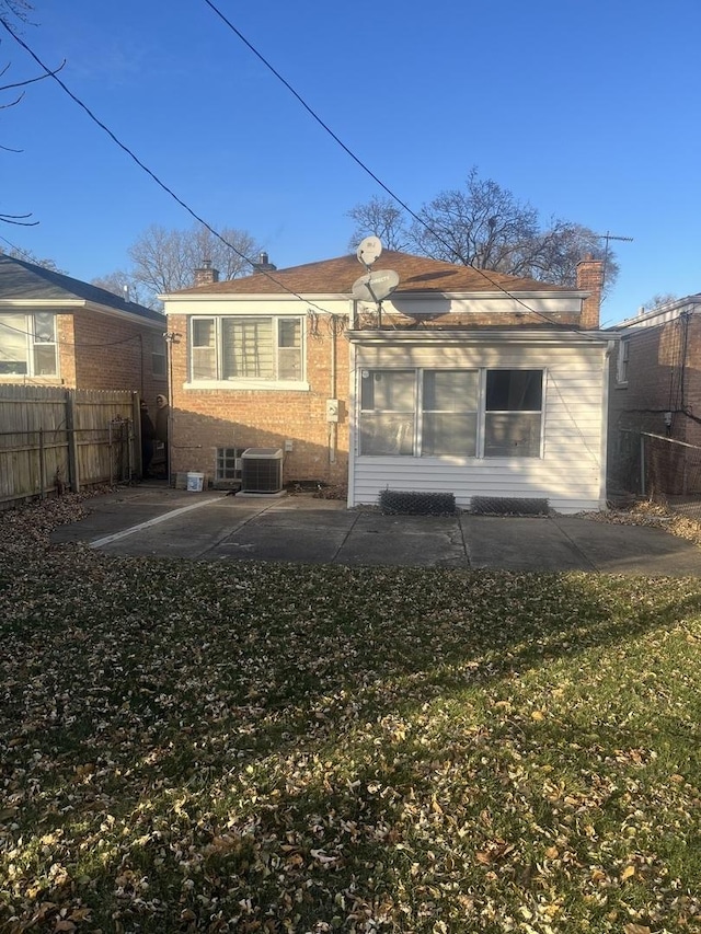 back of house with a yard and a patio