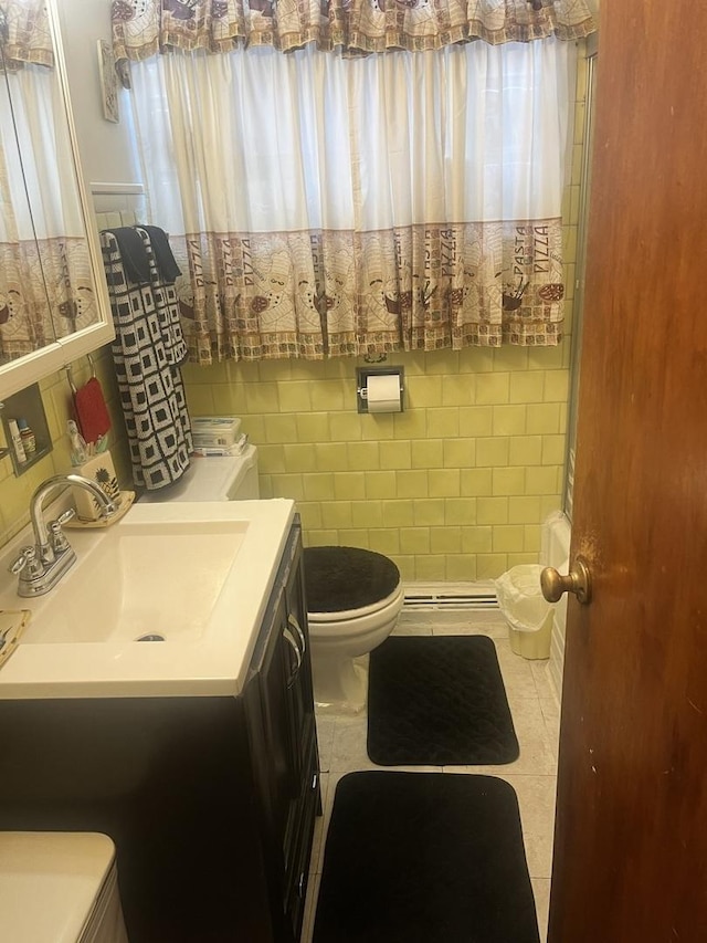 bathroom with tile patterned flooring, vanity, tile walls, and toilet