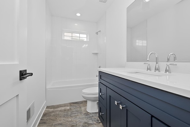 full bathroom featuring vanity, tiled shower / bath combo, and toilet