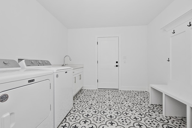 laundry area with cabinets, separate washer and dryer, and sink