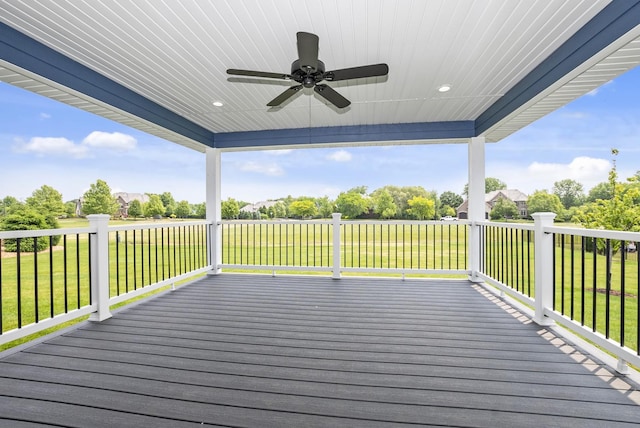 deck featuring ceiling fan and a yard