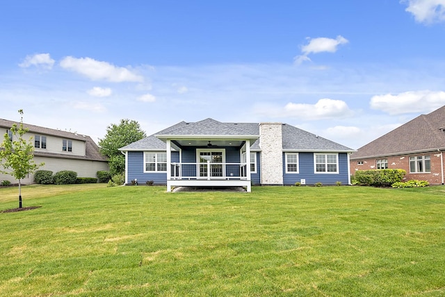 back of house featuring a lawn and ceiling fan