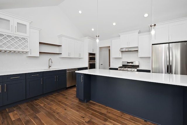 kitchen with white cabinets, sink, dark hardwood / wood-style floors, decorative light fixtures, and stainless steel appliances