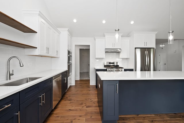 kitchen featuring dark hardwood / wood-style flooring, stainless steel appliances, sink, white cabinetry, and hanging light fixtures