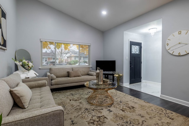 living room featuring hardwood / wood-style flooring and vaulted ceiling