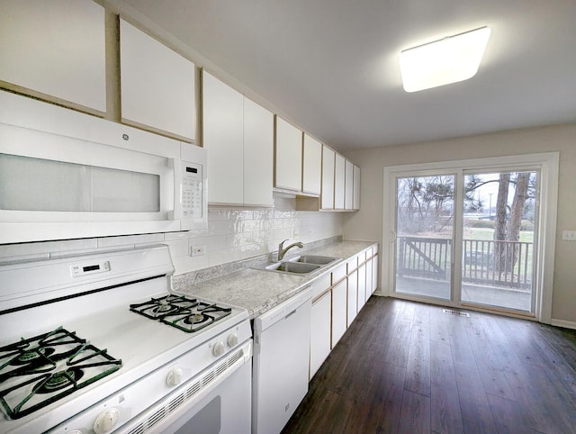 kitchen with white appliances, sink, tasteful backsplash, dark hardwood / wood-style flooring, and white cabinetry