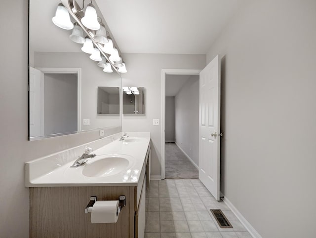 bathroom with tile patterned flooring and vanity