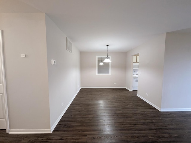 spare room featuring dark hardwood / wood-style flooring