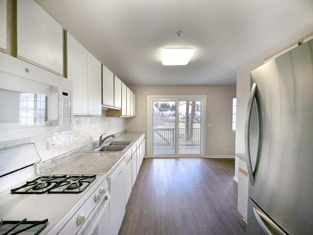 kitchen with white cabinetry, sink, dark hardwood / wood-style floors, and white appliances