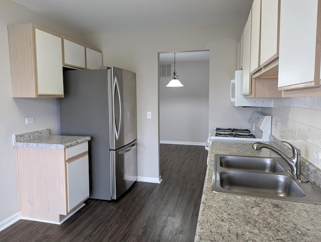 kitchen featuring hanging light fixtures, sink, dark hardwood / wood-style floors, and white appliances