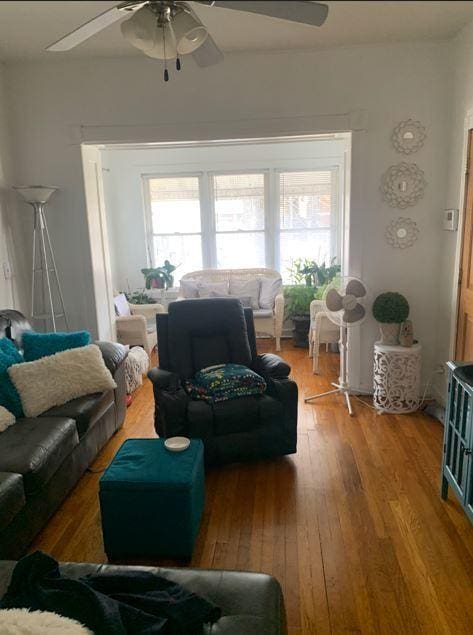 living room featuring hardwood / wood-style flooring, ceiling fan, and a healthy amount of sunlight