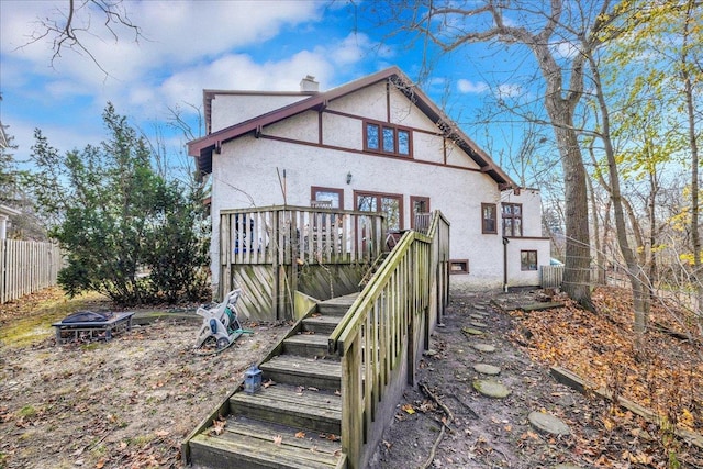 back of house with a wooden deck and central AC unit