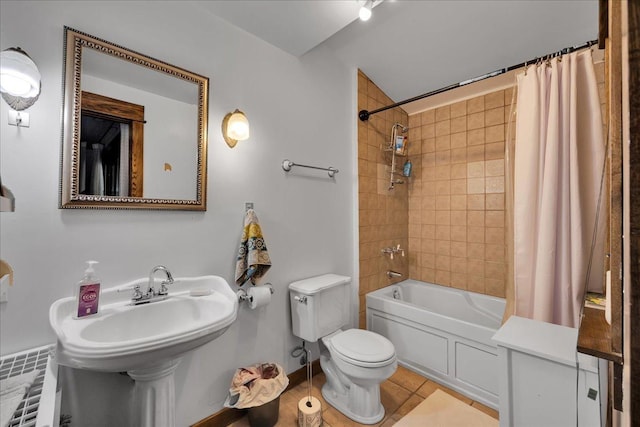 bathroom featuring toilet, tile patterned floors, and shower / tub combo with curtain