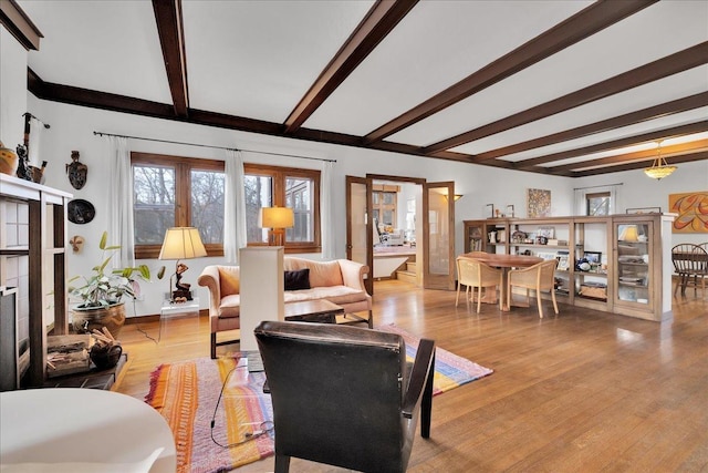 living room with beamed ceiling and light hardwood / wood-style floors