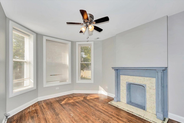 unfurnished living room featuring dark hardwood / wood-style floors and ceiling fan