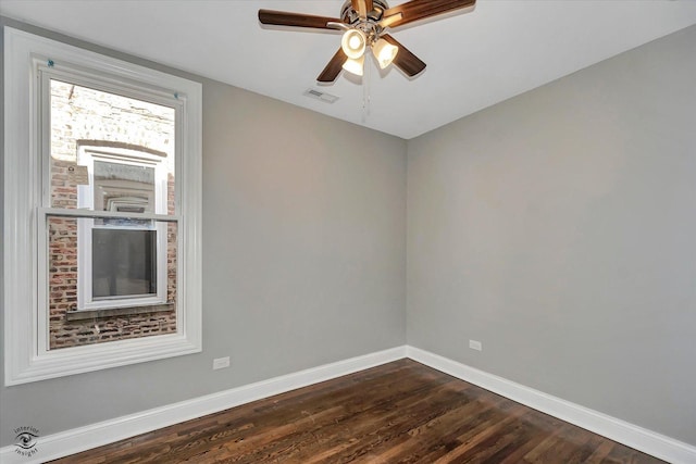 spare room featuring ceiling fan and dark wood-type flooring