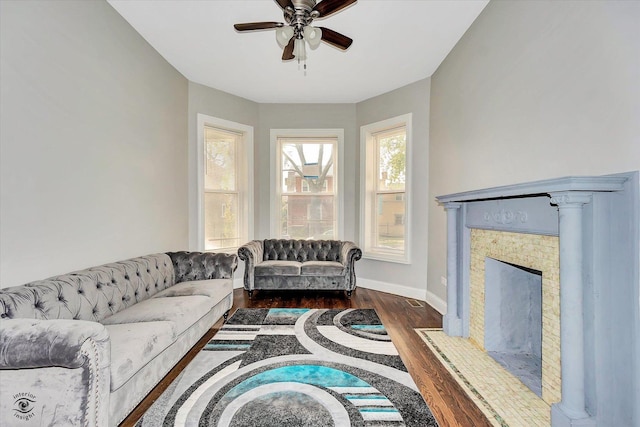 living room with dark hardwood / wood-style flooring and ceiling fan