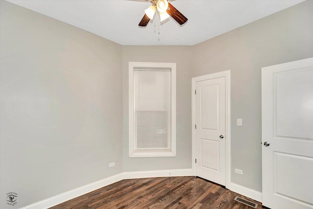 empty room featuring ceiling fan and dark wood-type flooring