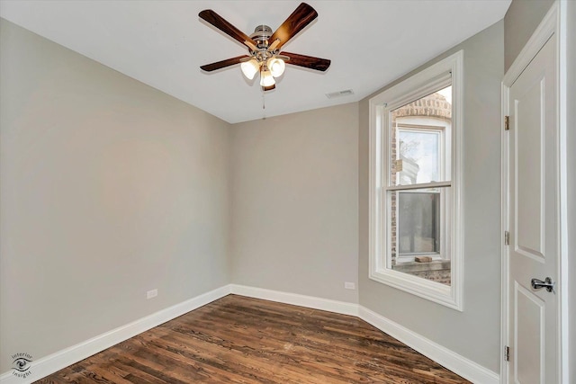 empty room featuring ceiling fan and dark wood-type flooring