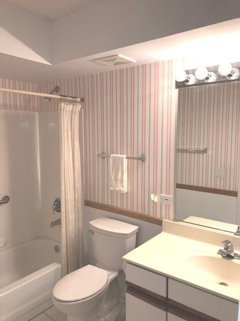 full bathroom with vanity, toilet, and shower / bath combo with shower curtain