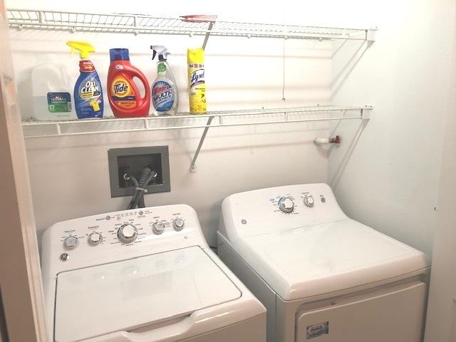 clothes washing area featuring independent washer and dryer