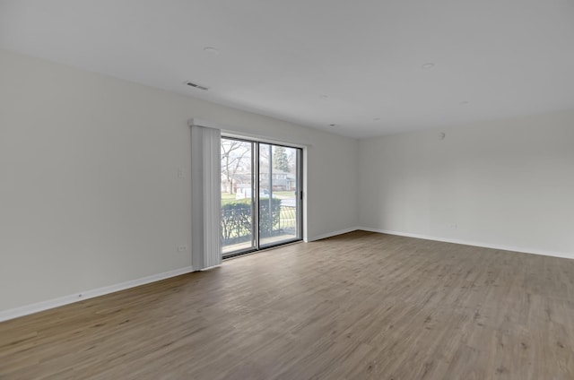 spare room featuring hardwood / wood-style flooring