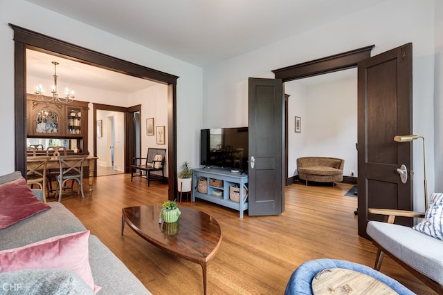 living room featuring light hardwood / wood-style floors and a notable chandelier