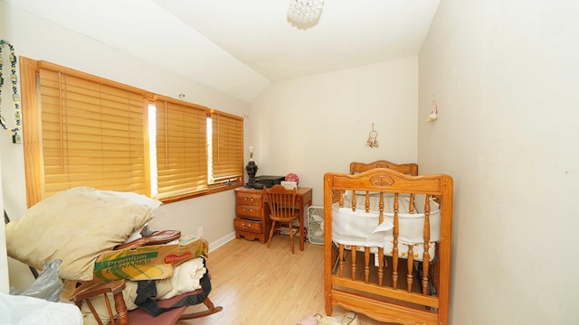 bedroom with vaulted ceiling and light hardwood / wood-style flooring