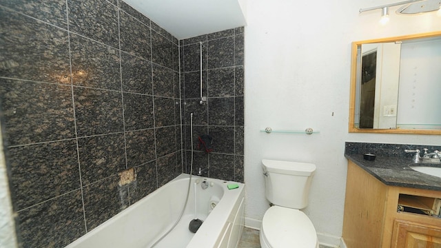 full bathroom featuring tiled shower / bath combo, toilet, and vanity