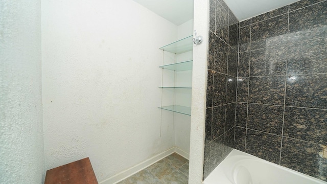 bathroom with tile patterned floors and tiled shower / bath combo