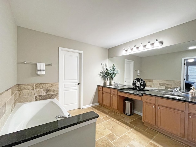 full bathroom with a bath, stone finish floor, and vanity