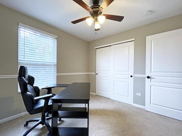 carpeted office with baseboards and ceiling fan