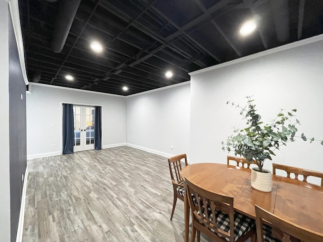 dining area with ornamental molding, french doors, baseboards, and wood finished floors